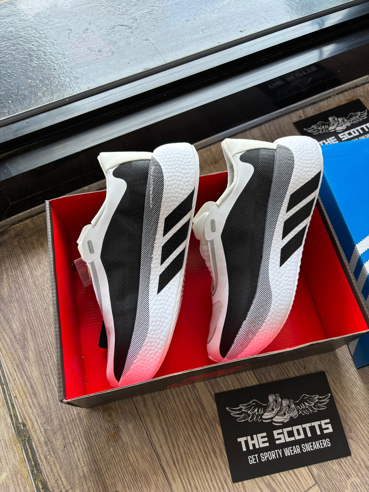 adidas Hyperboost Edge running shoe in a white and black