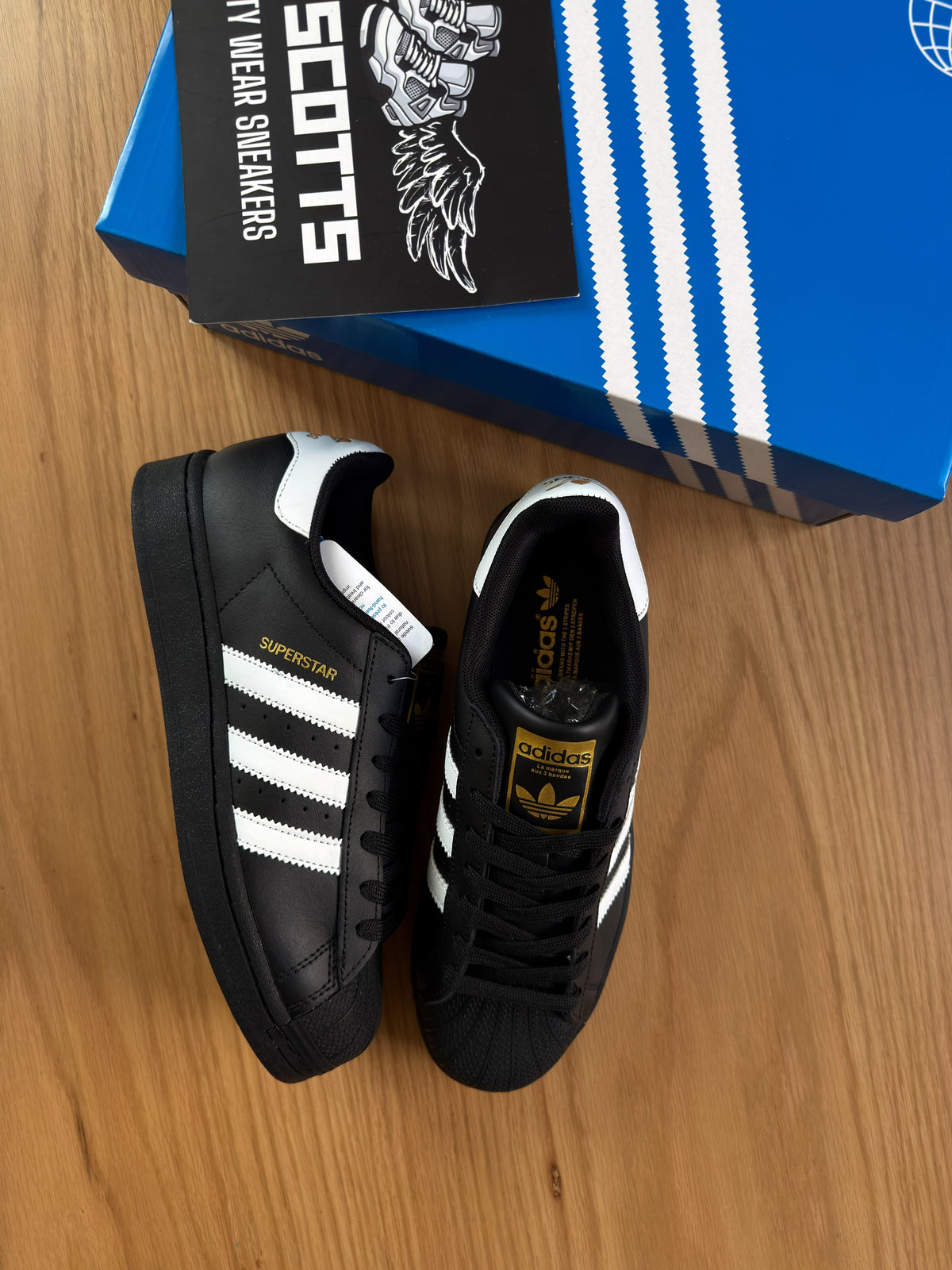 adidas super star in black